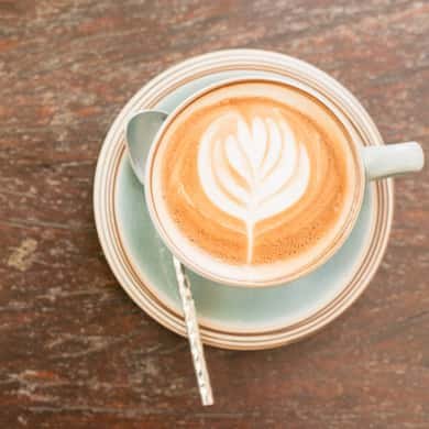 A small milky coffee finished with latte art