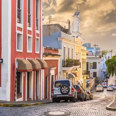 A pastel street in Old San Juan running down towards the cathedral tower