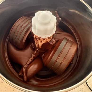Melted chocolate being worked in a steel pot on the farm